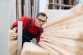 seller of the floor coverings store choosing the necessary samples of laminated boards . Royalty Free Stock Photo