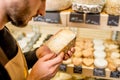 Holding a blue cheese at the store Royalty Free Stock Photo