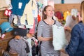 Seller offers pregnant woman baby dress in children clothing store Royalty Free Stock Photo