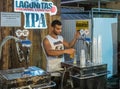 The seller pours beer near the stand of a brewing company Lagunitas at the Beer Festival on the promenade of Nahariya city in Isra Royalty Free Stock Photo