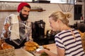 Seller presenting croissants to a customer Royalty Free Stock Photo