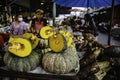 A seller is selling pumpkins that have been cut into half at the Ban Na Kluea Folk Market, Pattaya, Thailand