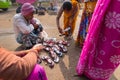 Seller selling shoes to sari clad Indian women, Kolkata, India