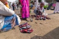 Seller selling shoes to sari clad Indian women, Kolkata, India