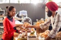 Seller serving a cake to the customer