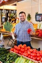 Seller shows vegetables.