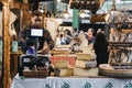 Seller weighing and wrapping cheese at the deli stand at Borough Market, London