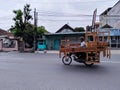 this is a seller of wooden beds.. who is traveling around offering his wares.. surabaya 21 May 2022 East Java Indonesia..