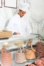 Seller in working clothes taking raw meat Royalty Free Stock Photo