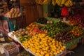 Selling fruits: mango, melon, watermelon, apples, cantaloupe, bananas, papaya, orange. Market on the street. Manila, Philippines.