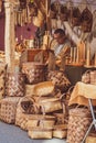 Selling handmade wooden tools, objects and wicker baskets in a folk arts and crafts fair