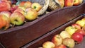 Selling ripe apples in a supermarket, close-up. Demonstration of apples on a wooden cart