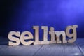 Selling, text words typography written with wooden letter on blue background, business motivational inspirational