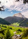 SELVA GARDENA, ITALY- SEPTEMBER 1, 2019: View across the town through trees to the Dolomite Mountains behind.