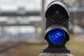 Semaphore with burning blue light. The intersection of railway tracks. - Image Royalty Free Stock Photo