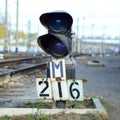 Semaphore with burning blue light. The intersection of railway tracks Royalty Free Stock Photo