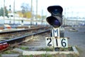 Semaphore with burning blue light. The intersection of railway tracks Royalty Free Stock Photo