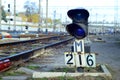 Semaphore with burning blue light. The intersection of railway tracks Royalty Free Stock Photo