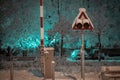 Semaphore or signal for oncoming train with barriers in night time. Grade crossing with lights and barriers in snowy weather at