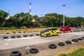 Yellow Suzuki Swift hatchback racing with a Honda jazz on local drag strip
