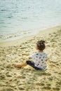 Children playing beside the beach near Sembawang Park, Singapore.