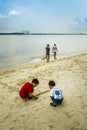 Children playing beside the beach near Sembawang Park, Singapore.