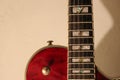 A semi acoustic electric guitar in red color