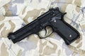 Semi-automatic handgun on camouflage background. Royalty Free Stock Photo