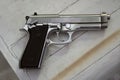 Semi-automatic handgun on grey wooden background Royalty Free Stock Photo