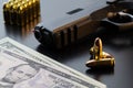 Semi-automatic pistol, bullets and dollar banknotes on black background Royalty Free Stock Photo