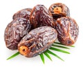 Semi-dried dates or date palm fruits lie on palm leaves isolated on white background. File contains clipping path