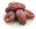 Semi-dried dates or date palm fruits lie on palm leaves isolated on white background. File contains clipping path