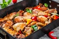 Semi-fried chicken meat with colorful pieces of peppers