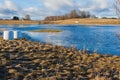 Semi-frozen autumn lake with two white swans swimming in it Royalty Free Stock Photo