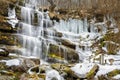 Semi frozen waterfall Tupavica and moss covered rocks