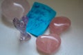 Semi-precious stones in different shapes.Quartz hearts and amethyst angel, love message on blue post-it