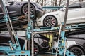 A semi-tracker trailer hauling seven Tesla Models 3 and X, painted white, black and silver, sits parked overnight in a parking lot