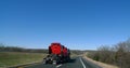 Semi tractor hauling semi trucks, red, on highway Royalty Free Stock Photo