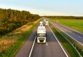 Semi-trailer truck DAF driving along highway on blue sky background. Semi trucks on road. Lorry concept. Goods Delivery by roads.