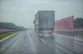 Semi-trailer truck driving on the highway with other cars during heavy rain in summer, wet road. Traffic on the road Royalty Free Stock Photo