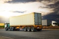 Semi Trailer Truck Driving on Highway Road with The Sunset. Freight Trucks Logistics Cargo Transport. Royalty Free Stock Photo