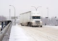 Semi trailer truck driving in winter snow storm