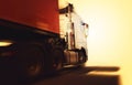 Semi Trailer Truck with Speeding Motion in the Sunset. Delivery Trucks Driving on the Road. Cargo Shipping. Diesel Truck Lorry