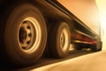 Semi Trailer Truck with Speeding Motion in the Sunset. Fast Spinning Wheels. Trucks Driving on the Road. Diesel Freight Truck. Royalty Free Stock Photo