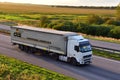 Semi-trailer truck VOLVO by DLS Spedition Logistics driving along highway on blue sky background. Goods Delivery by roads. MINSK,