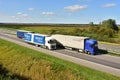 Semi-trailer Trucks DAF driving on highway. Truck on asphalt road overtakes another truck. Goods Delivery. Services and Transport