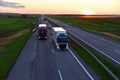 Semi-trailer Trucks Mercedes-Benz Actros and VOLVO driving on highway. Truck on asphalt road overtakes another truck. Services and