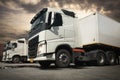 Semi TrailerTrucks Parked Lot at The Sunset Sky. Shipping Container. Delivery, Transit. Engine Diesel Truck Tractor. Freight Royalty Free Stock Photo