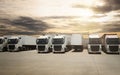 Semi TrailerTrucks Parked Lot with The Sunset Sky. Shipping Container. Delivery Transit. Diesel Trucks. Lorry Tractor. Logistics Royalty Free Stock Photo