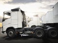 Semi TrailerTrucks Parked with The Sunset Sky. Shipping Container Trucks. Engine Diesel Trucks. Lorry Tractor. Freight Trucks. Royalty Free Stock Photo